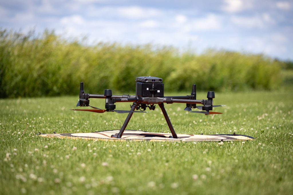 Drone on pad in grass field