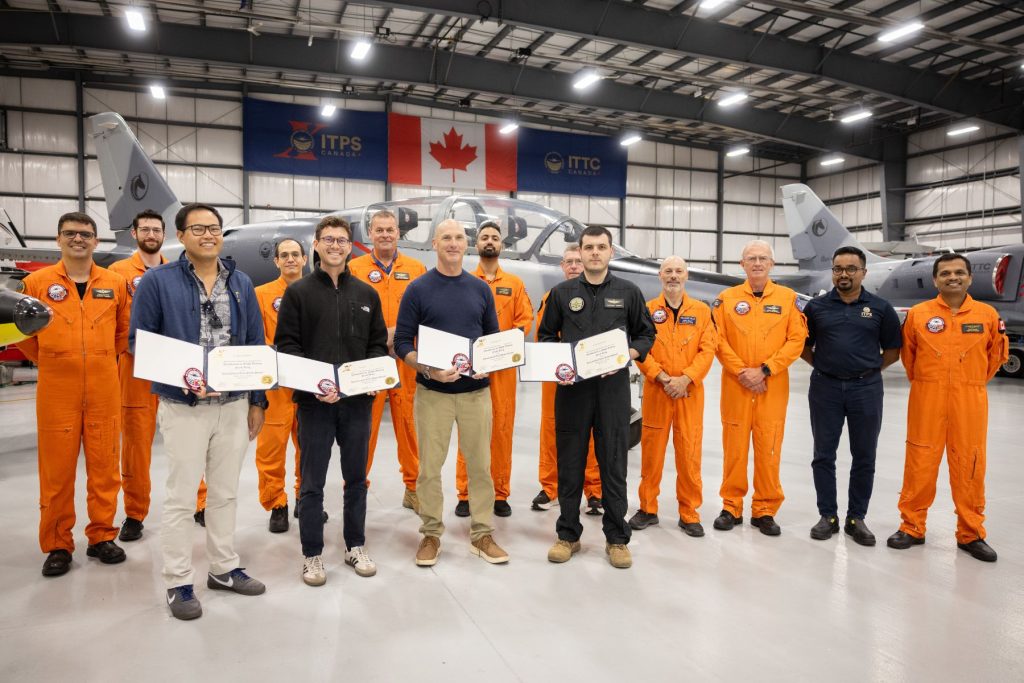 ITPS graduates in front of L39 in ITPS hangar with instructors