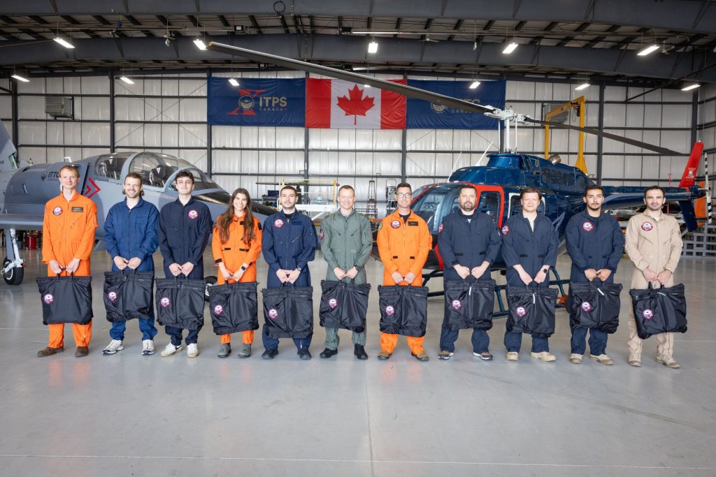 1783536390783 New 2026 students in ITPS hangar in front of aircraft