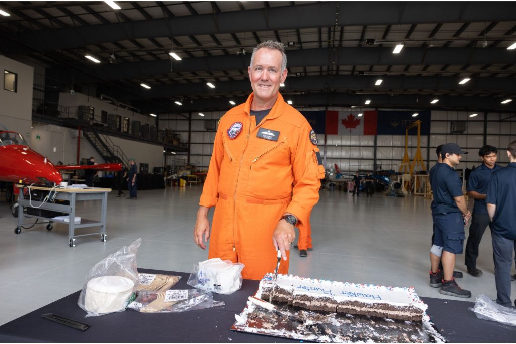 2 Dave Lohse, CEO of ITPS, cutting cake in ITPS hangar