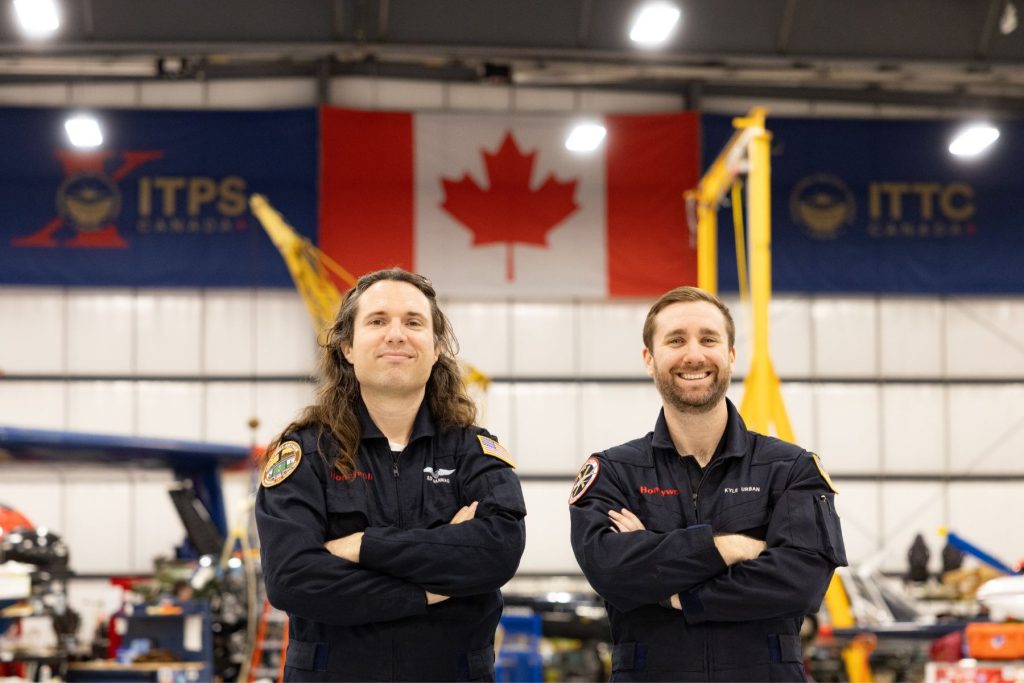 5 Honeywell Aerospace students in flight suits in ITPS hangar