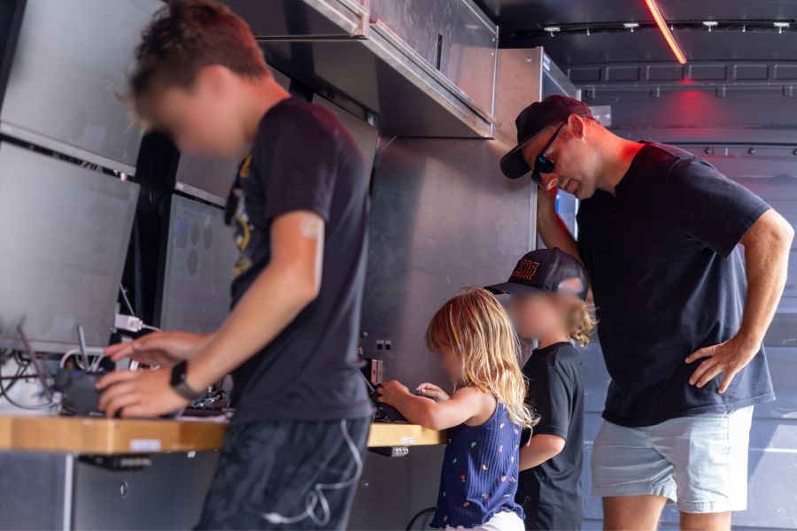kids looking inside UAS Ground Control Centre screens