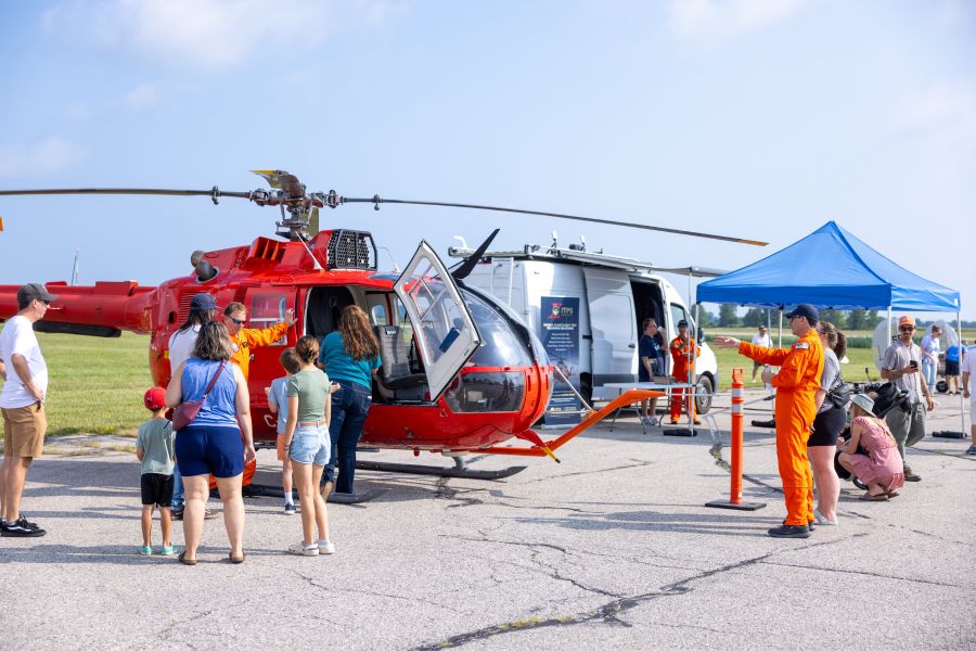 ITPS Bo105 and UAS van with drones on display while attendees look