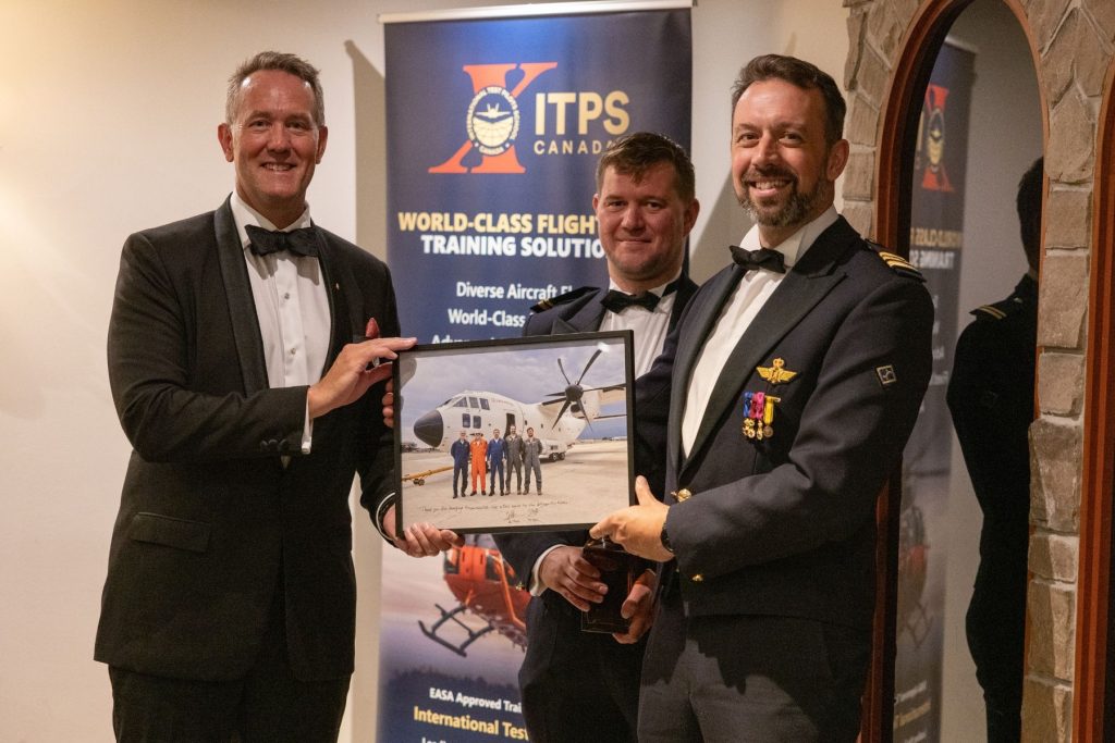 1786564715912 Dave Lohse, CEO holding photo of graduating students with the fixed wing class