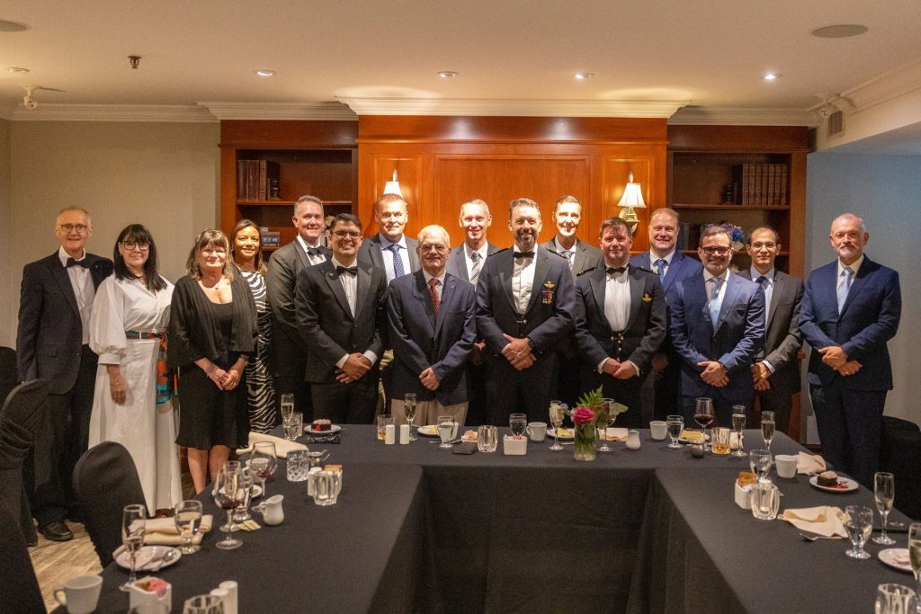 1786564716235 Graduates and ITPS team stand together in suit and tie gathering