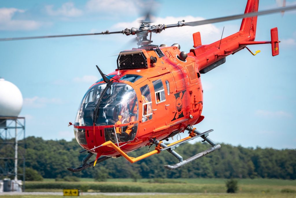 Bo105 helicopter flying low with flight test instrumentation