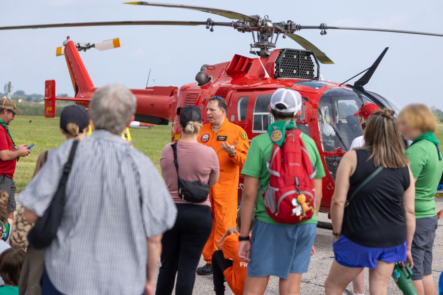 Mark Chivers, Head of Rotary Wing at ITPS, speaking to group of spectators in front of Bo105