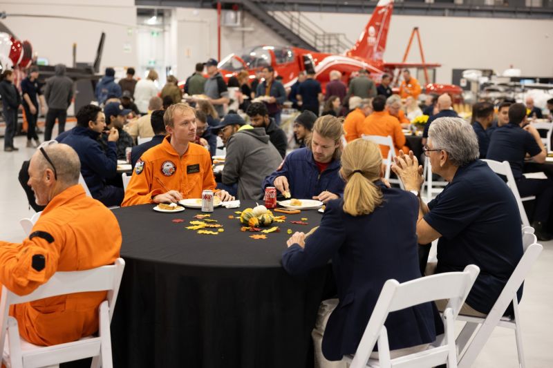 1791746783408 ITPS students with staff at thanksgiving table