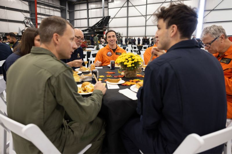 1791746783865 Students and instructors sitting at thanksgiving table